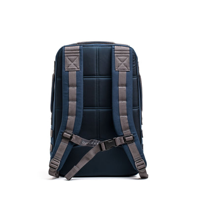 The Rucker 4.0, shown from the back in navy blue, features padded straps and a chest buckle for comfortable rucking, displayed against a white background.