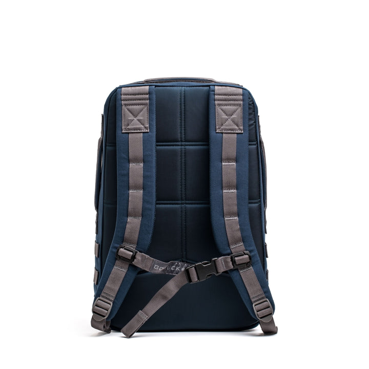 The Rucker 4.0, shown from the back in navy blue, features padded straps and a chest buckle for comfortable rucking, displayed against a white background.