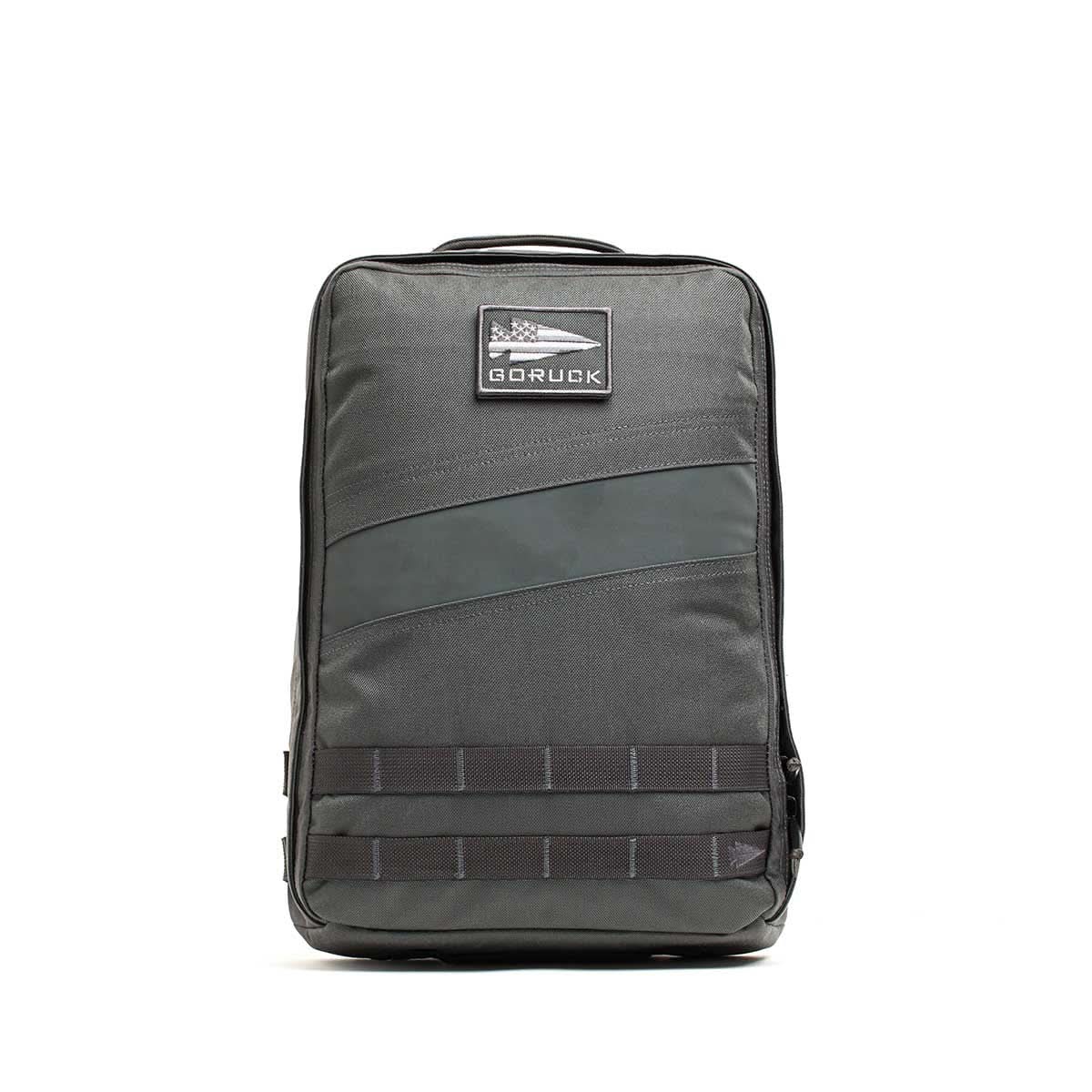A gray Rucker 4.0 rucksack with a front patch and black horizontal bottom straps, ideal for rucking adventures.