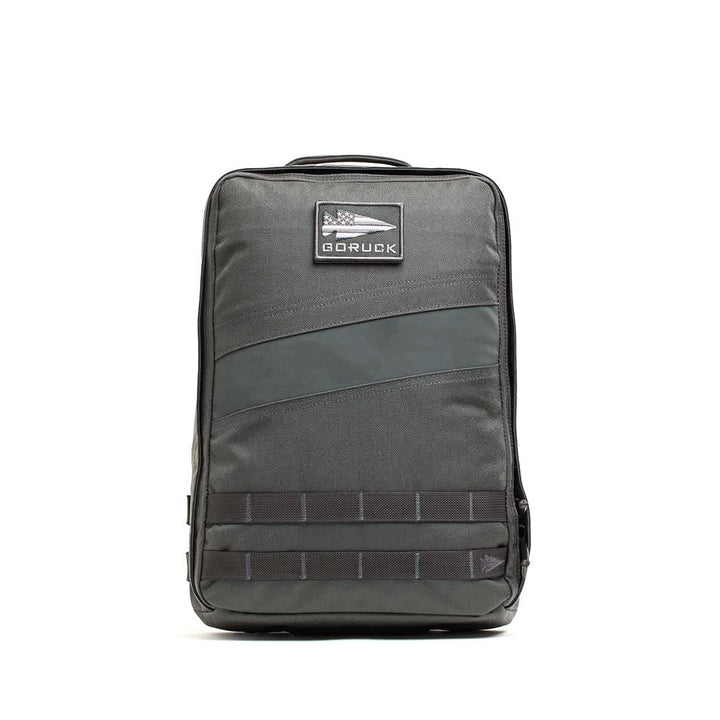 A gray Rucker 4.0 rucksack with a front patch and black horizontal bottom straps, ideal for rucking adventures.