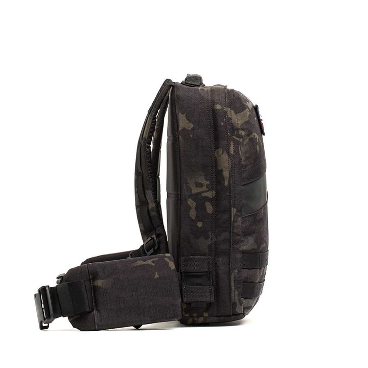 Side view of a black camo Rucker 4.0 sling rucksack featuring padded strap and buckles, shown against a white background.