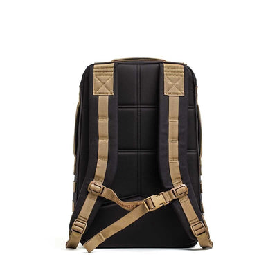 The Rucker 4.0, a black rucksack with padded tan shoulder straps and a chest buckle, is shown from the back against a white background.