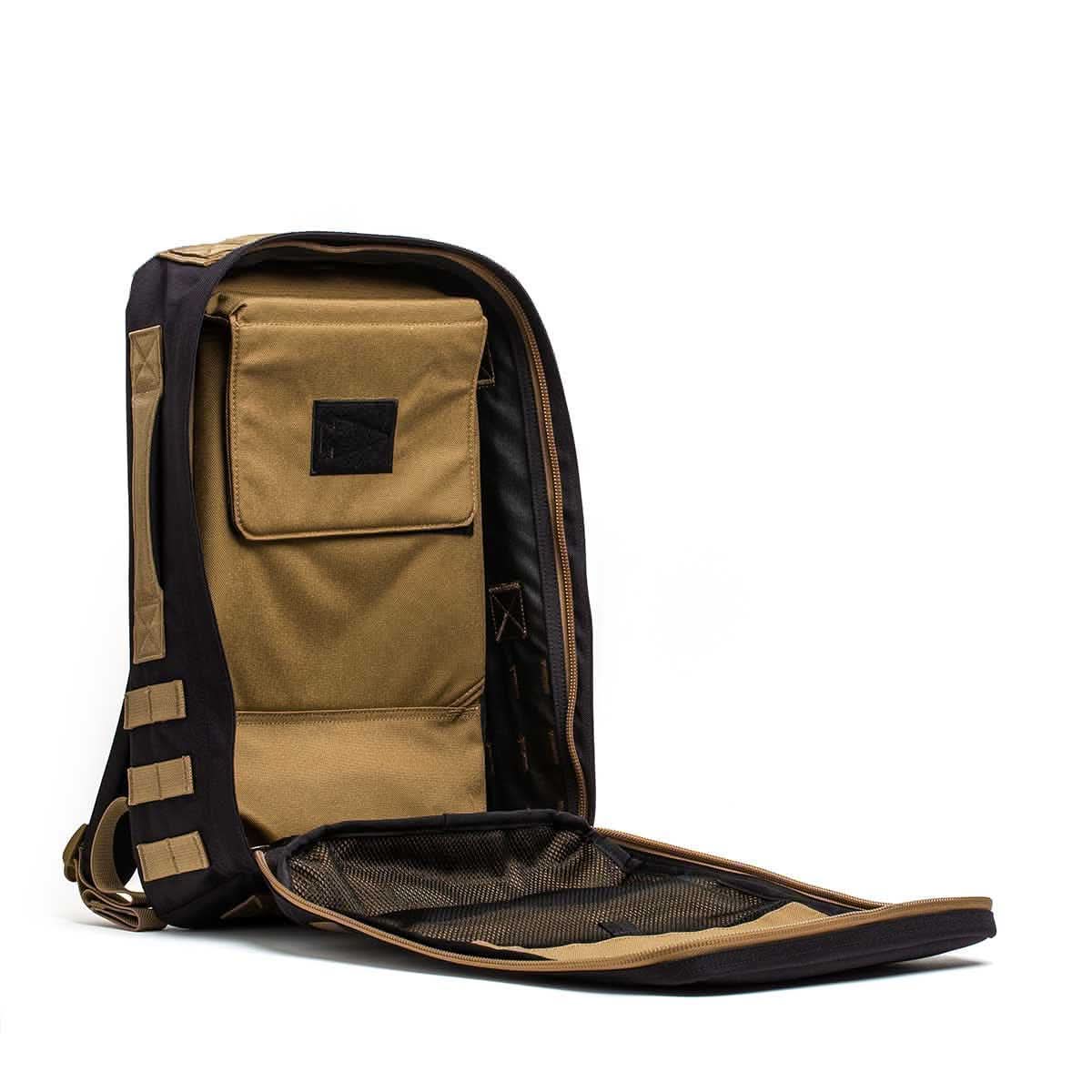 The Rucker 4.0 rucksack in brown and black is shown with the front fully unzipped, displaying its inner pocket and mesh compartment.