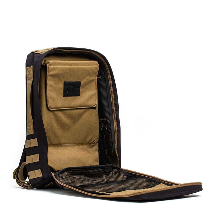 The Rucker 4.0 rucksack in brown and black is shown with the front fully unzipped, displaying its inner pocket and mesh compartment.