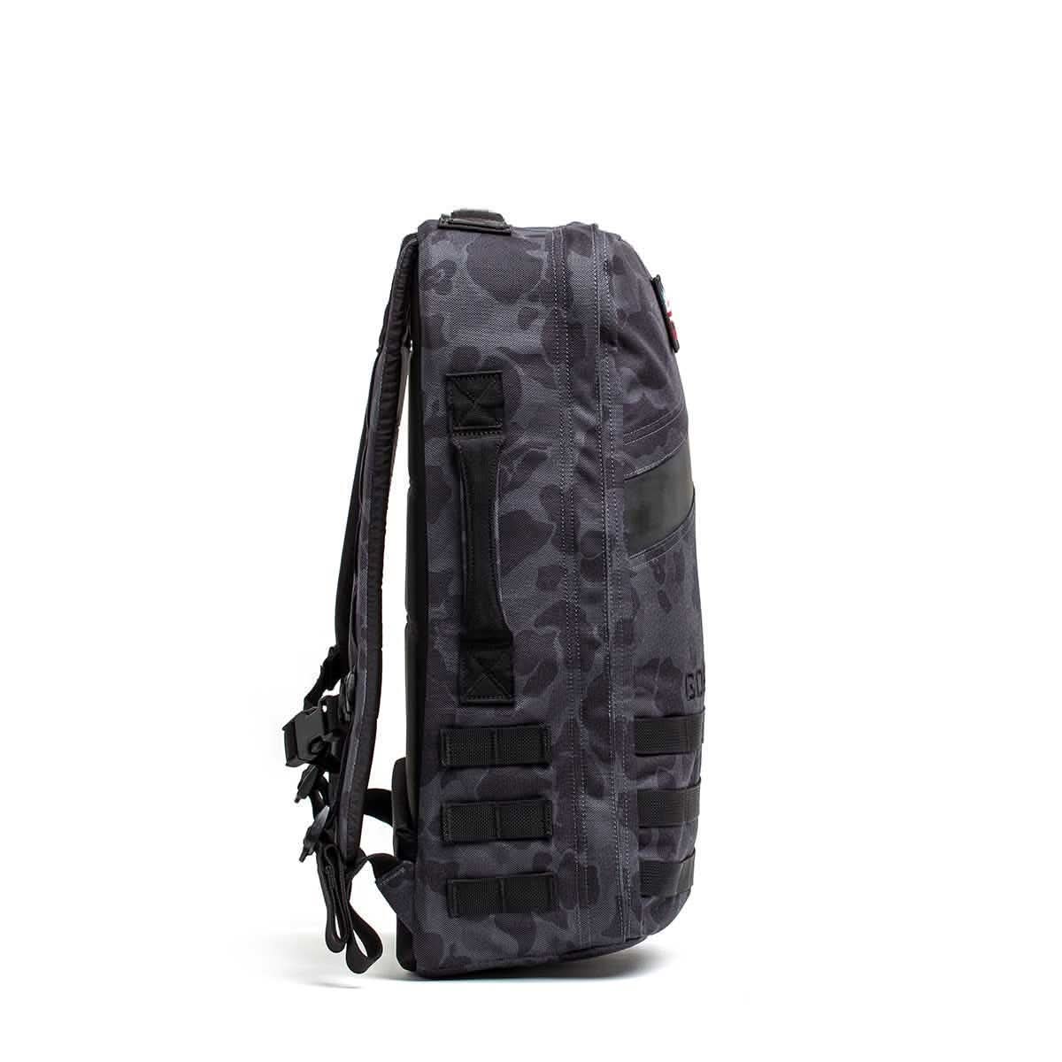 Side view of the Rucker 4.0, a black and gray camouflage rucksack with multiple straps and a zippered pocket, ideal for rucking adventures.