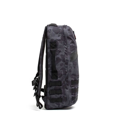 Side view of the Rucker 4.0, a black and gray camouflage rucksack with multiple straps and a zippered pocket, ideal for rucking adventures.