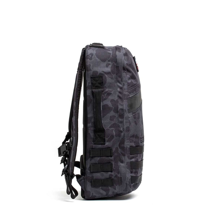 Side view of the Rucker 4.0, a black and gray camouflage rucksack with multiple straps and a zippered pocket, ideal for rucking adventures.