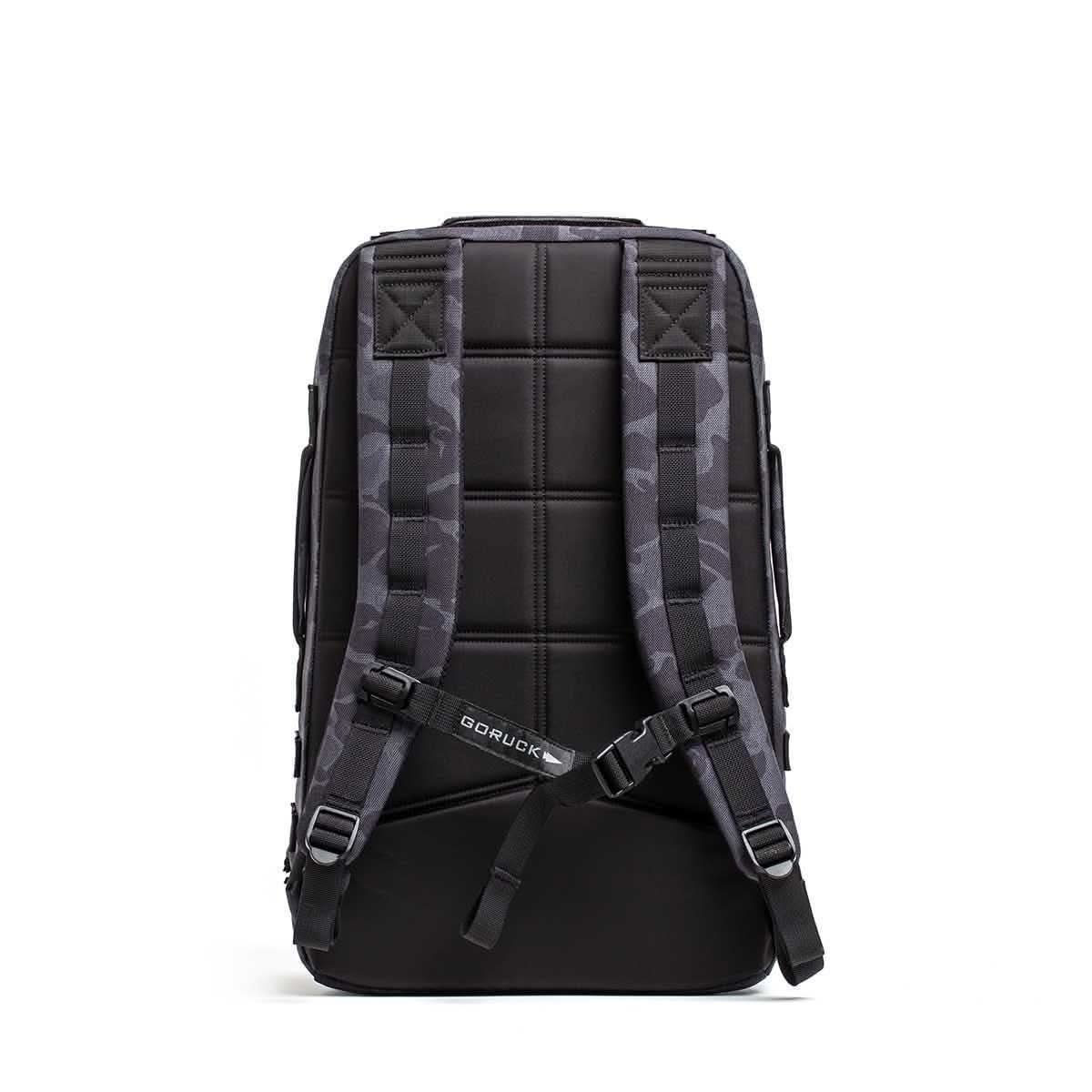 The Rucker 4.0 rucksack in black, shown from the back with padded shoulder straps and a quilted back panel.