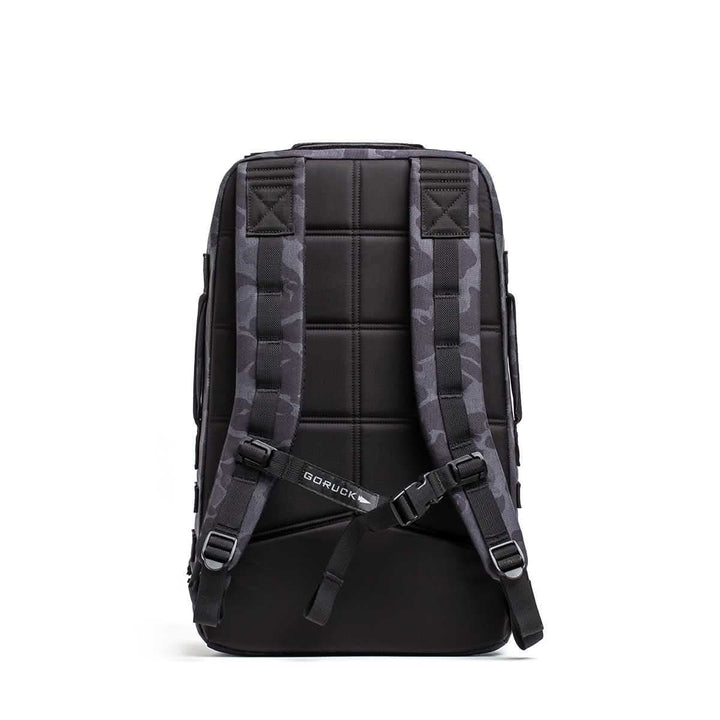 The Rucker 4.0 rucksack in black, shown from the back with padded shoulder straps and a quilted back panel.