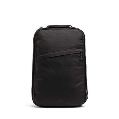 The GR1 USA Slick - Ballistic Nylon Cordura is a black rectangular backpack with a front zipper pocket and bombproof laptop compartment, shown standing upright against a white background.
