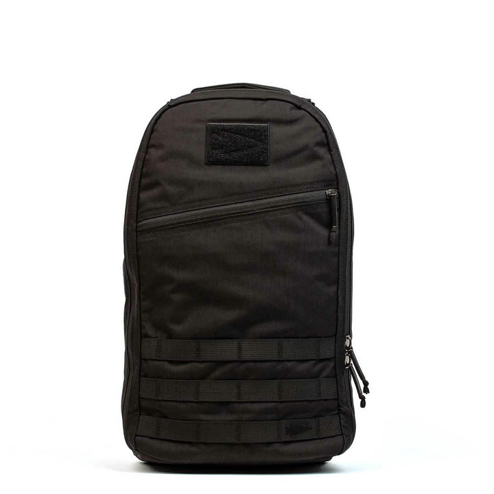 The Bullet Ruck Laptop - 16L by GORUCK is a sleek black backpack that seamlessly combines style with functionality. It includes a zippered front pocket, two side zippers, and a top handle. Designed for everyday use, this durable backpack offers subtle lumbar support and comes equipped with a laptop compartment.