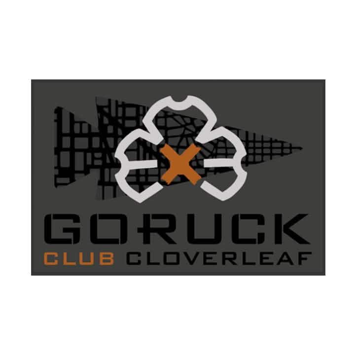 Patch for GORUCK's Ruck Club Cloverleaf, showcasing a stylized cloverleaf design with a star in the center. The background includes a dark grid pattern, symbolizing the spirit of community fitness within ruck clubs.