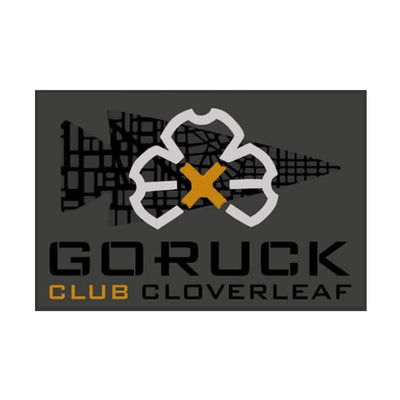 Patch for the GORUCK Ruck Club Cloverleaf showcasing a stylized cloverleaf design intersected by a yellow X on a dark background. The bold lettering spells out "GORUCK Ruck Club Cloverleaf," embodying the spirit of community fitness and ruck club camaraderie.