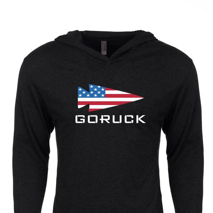 The GORUCK USA Hoodie - Tri-Blend by GORUCK is a black hoodie that features the iconic GORUCK logo, with a stylized spearhead adorned with an American flag design and the word "GORUCK" boldly printed in white underneath, embodying Special Forces heritage inspiration.