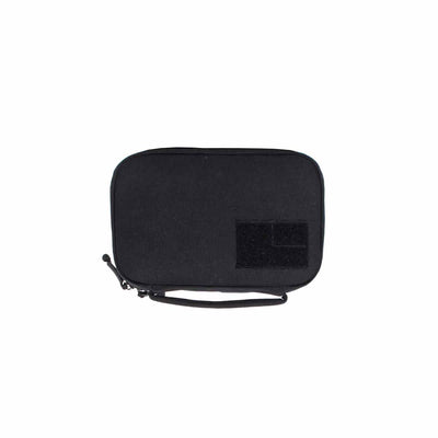 The GR1 Field Pocket by GORUCK is a compact black fabric pouch equipped with a zipper and a side wrist strap. Designed as an ideal electronics organizer, it features a rectangular velcro patch on the front for enhanced convenience.