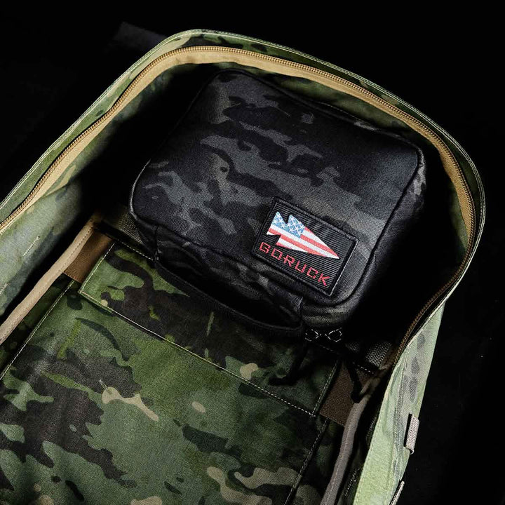 Open the GR2 Field Pocket - Black Multicam to find a black pouch inside, perfect as a dopp kit or electronics organizer, and featuring an American flag patch labeled "GORUCK.