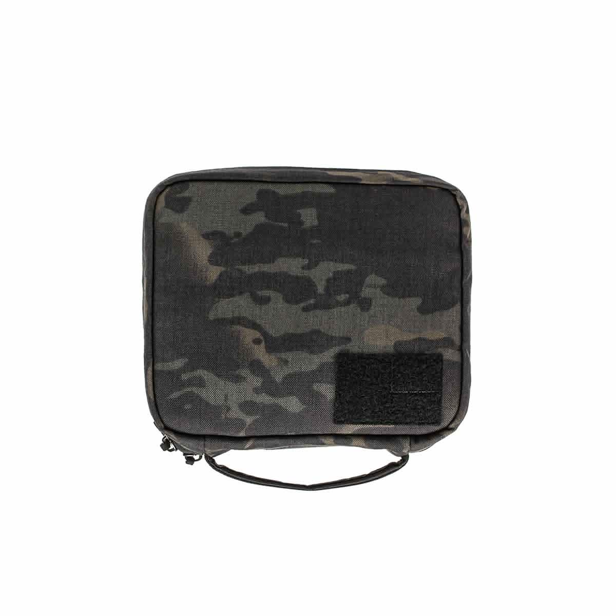 The GR2 Field Pocket - Black Multicam is a square camouflage pouch with zipper, handle, and a black Velcro patch—ideal as a compact dopp kit or electronics organizer for your essentials.