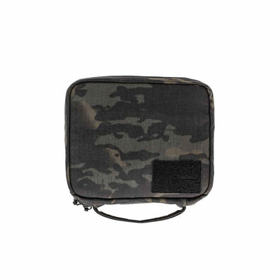 The GR2 Field Pocket - Black Multicam is a square camouflage pouch with zipper, handle, and a black Velcro patch—ideal as a compact dopp kit or electronics organizer for your essentials.