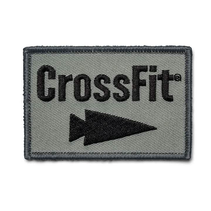 The GORUCK-DEMO Patch - GORUCK x CrossFit features a rectangular embroidered design with a green background that prominently displays 'CrossFit' in bold black letters. A black arrow below points to the right, completing the GORUCK-inspired look with a sturdy black stitched border.