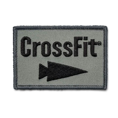 The GORUCK-DEMO Patch - GORUCK x CrossFit features a rectangular embroidered design with a green background that prominently displays 'CrossFit' in bold black letters. A black arrow below points to the right, completing the GORUCK-inspired look with a sturdy black stitched border.