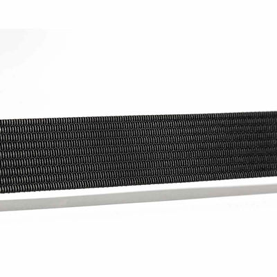 Close-up of a black rectangular object, possibly a Spearhead Web Belt by Grip 6, laid horizontally against a white background. The low profile design features thin, parallel ridges and a no-slip locking mechanism for added security.