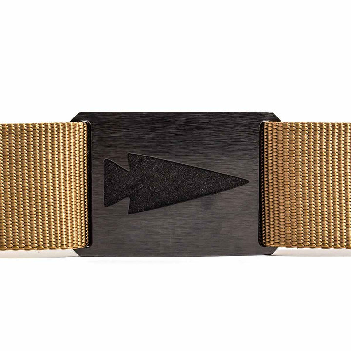 A close-up of the Spearhead Tactical Belt by Grip 6 showcases its tan woven design with a black buckle. The buckle, engraved with an arrowhead silhouette, delivers a rugged and minimalistic look. The textured belt sharply contrasts with the smooth finish of the buckle, making it perfect for endurance events.