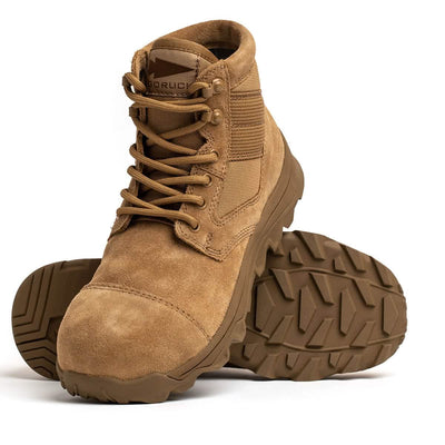 The MACV-2 Safety Boot - Mid Top by GORUCK in tan showcases one boot standing upright and the other leaning against it. Designed to meet Special Forces standards, these boots come with rugged soles, laces, and a textured, durable design ideal for challenging outdoor activities.