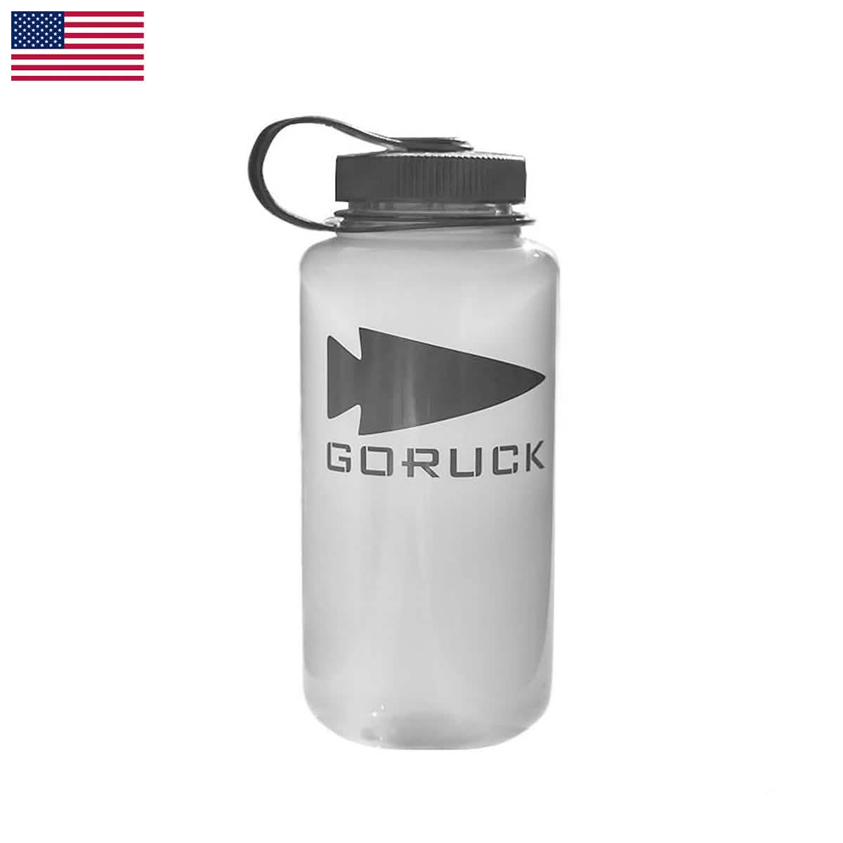 A sturdy Nalgene Water Bottle (32oz) - GORUCK Spearhead with a black cap and handle, showcases an arrowhead logo alongside the word GORUCK in black. It features an American flag on the top left corner on a white background, ideal for adventure enthusiasts.