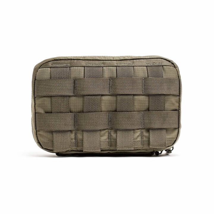 Introducing the GR1 Field Pocket - Ripstop ROBIC® by GORUCK, a durable rectangular-shaped tactical pouch designed to withstand tough conditions. Made from ripstop nylon, it features reinforced grid-like stitching and water-resistant webbing on the front, allowing for easy attachment of additional gear. This versatile pouch is ideal as an electronics organizer and is perfect for outdoor activities or military use.