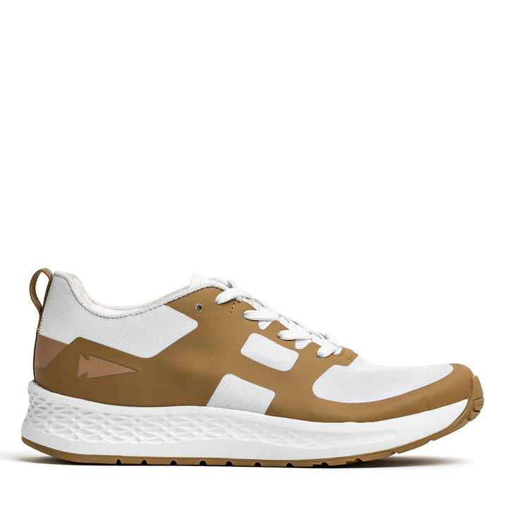The Men's Rough Runner - Speed Tan by GORUCK features a sleek design with a textured sole and lace-up style. It includes white and brown colors, geometric patterns on the side, and a pull tab at the heel. Its gradient density makes it perfect for casual outings as well as high-mileage athletic activities.