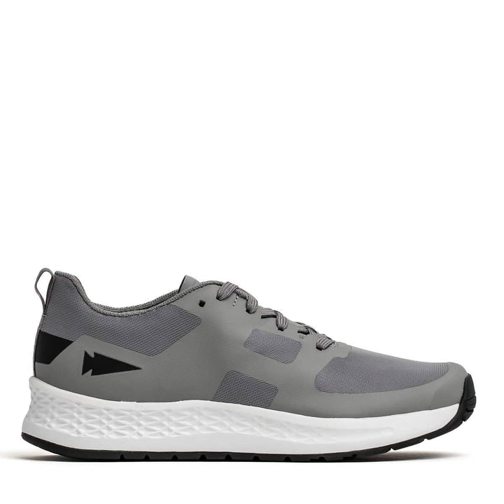 Introducing the Women's Rough Runner - Speed Grey + White by GORUCK: This gray athletic shoe boasts a lace-up design, complemented by a sleek black arrow detail on the heel. It features an EVA midsole with gradient density and a durable black outsole, making it ideal for both running and casual wear.